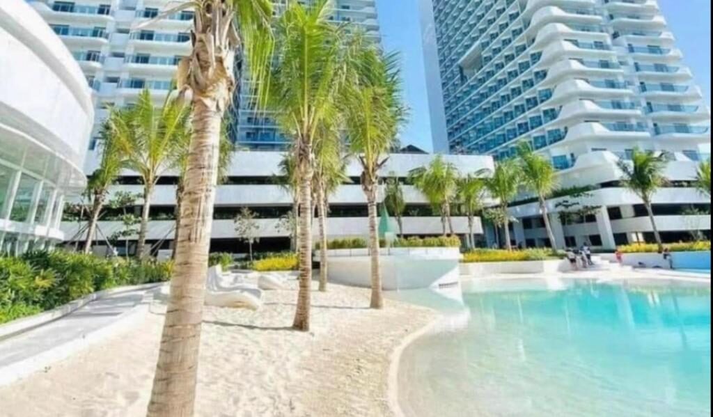 Turquoise pool framed by palms